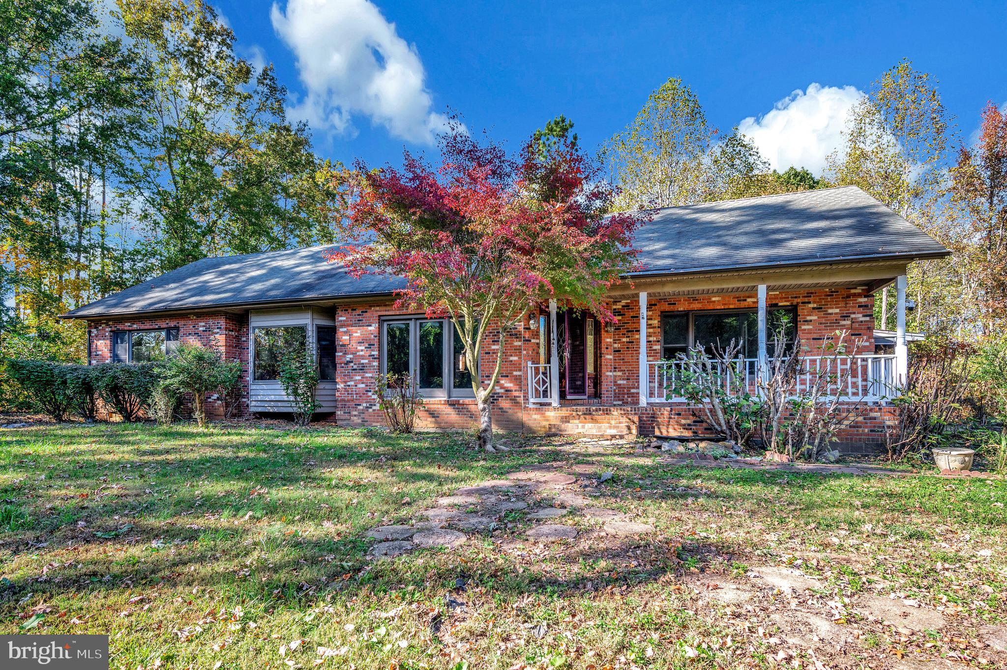 6709 Marye Road Spotsylvania, VA 22551 - Photo 2 of 73 a front view of a house with a garden and patio