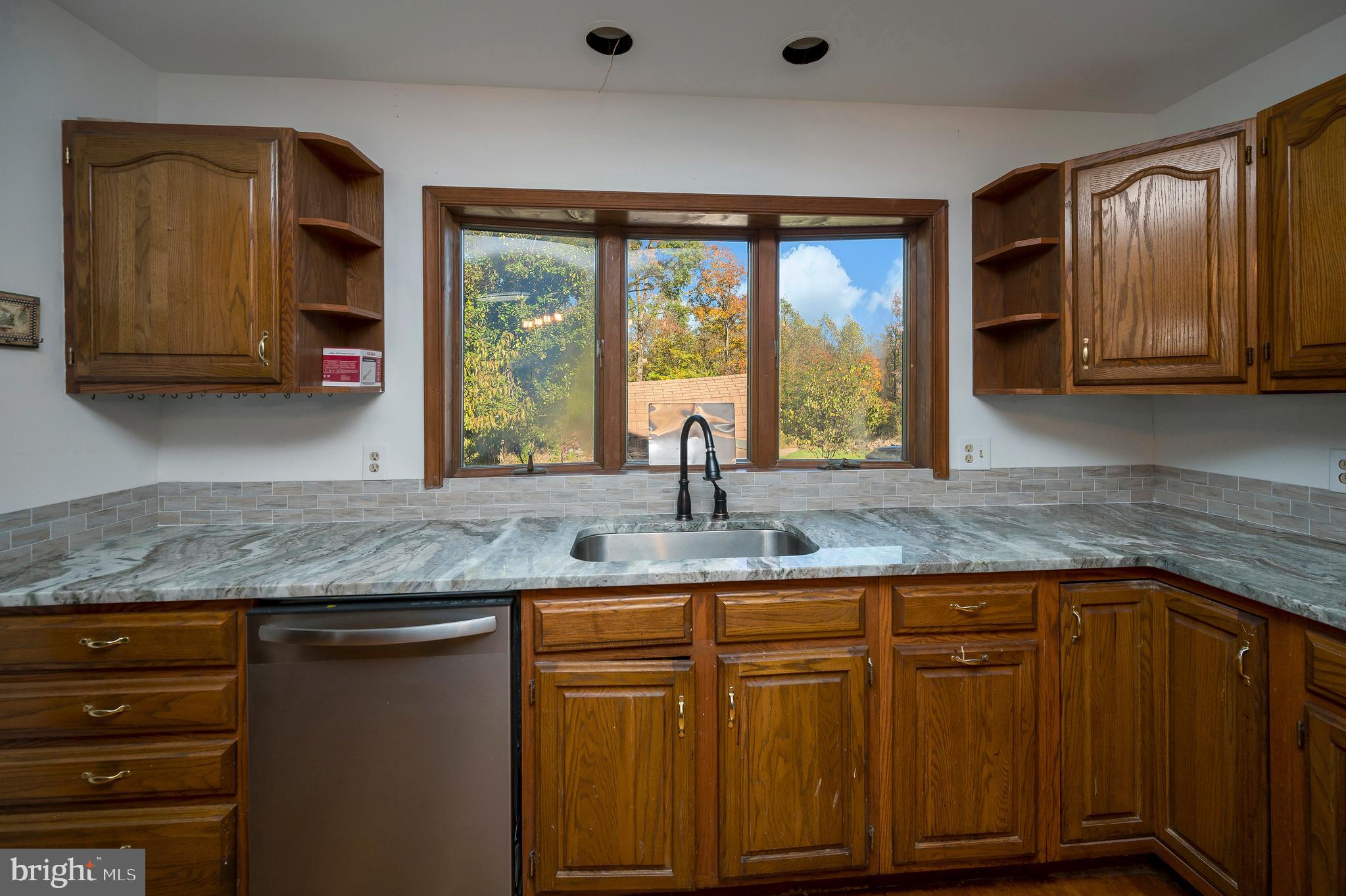 6709 Marye Road Spotsylvania, VA 22551 - Photo 44 of 73 a kitchen with granite countertop a sink and a window