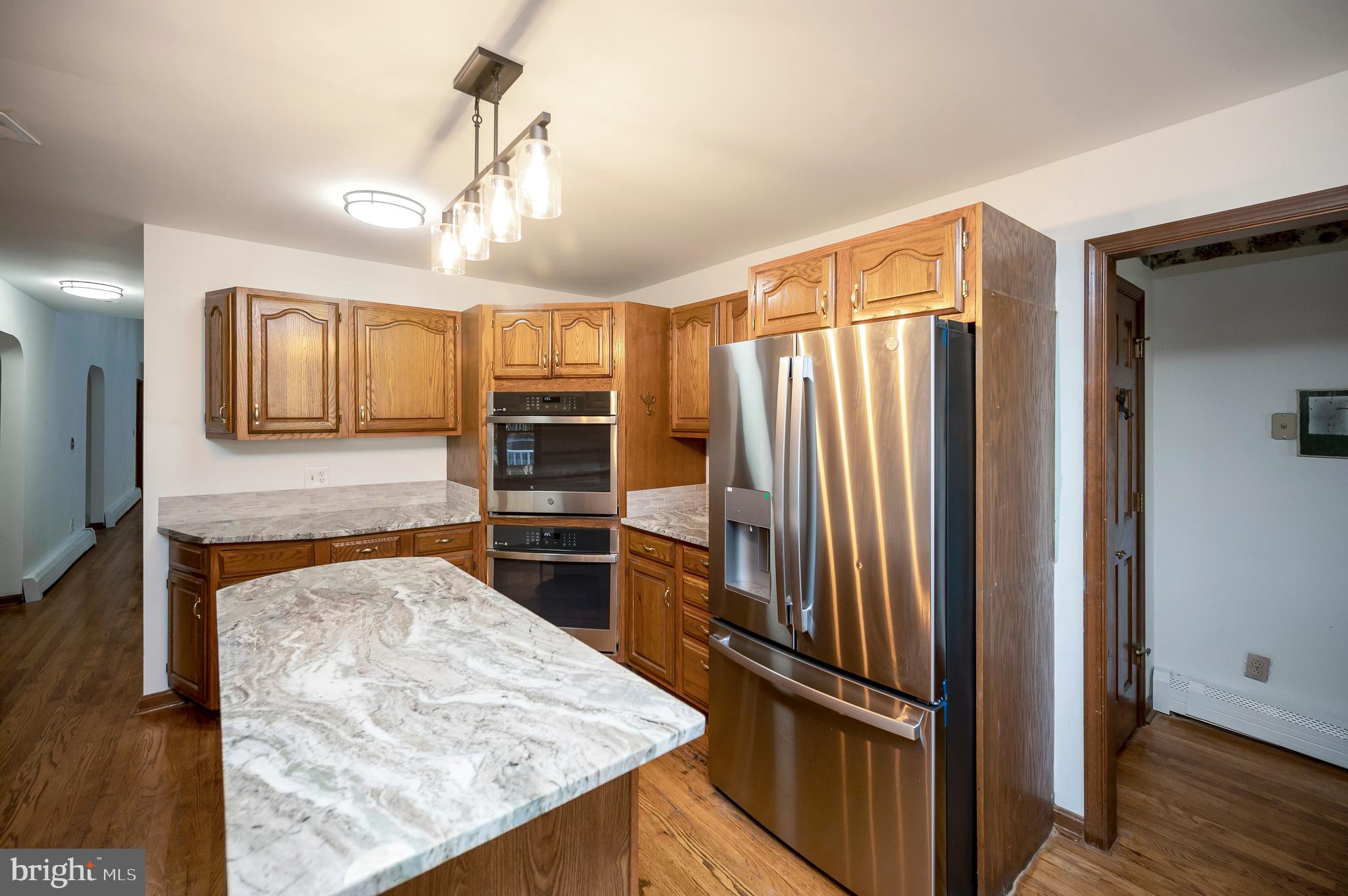 6709 Marye Road Spotsylvania, VA 22551 - Photo 46 of 73 a kitchen with stainless steel appliances granite countertop a refrigerator oven stove sink and cabinets