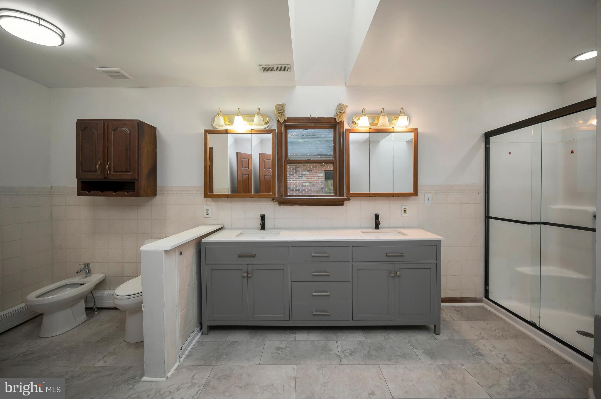 6709 Marye Road Spotsylvania, VA 22551 - Photo 57 of 73 a spacious bathroom with a double vanity sink toilet and mirror