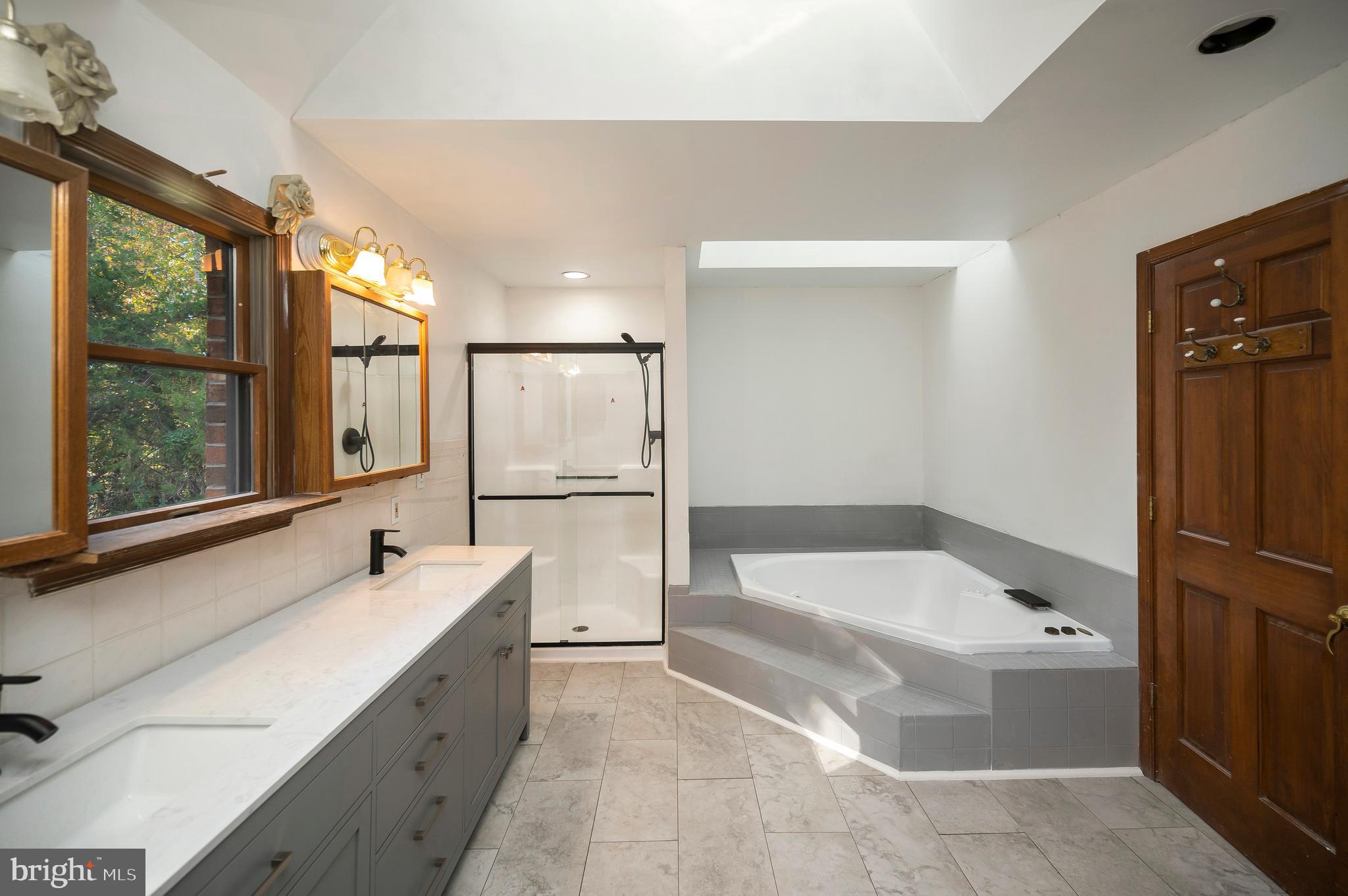 6709 Marye Road Spotsylvania, VA 22551 - Photo 58 of 73 a bathroom with a tub sink and mirror