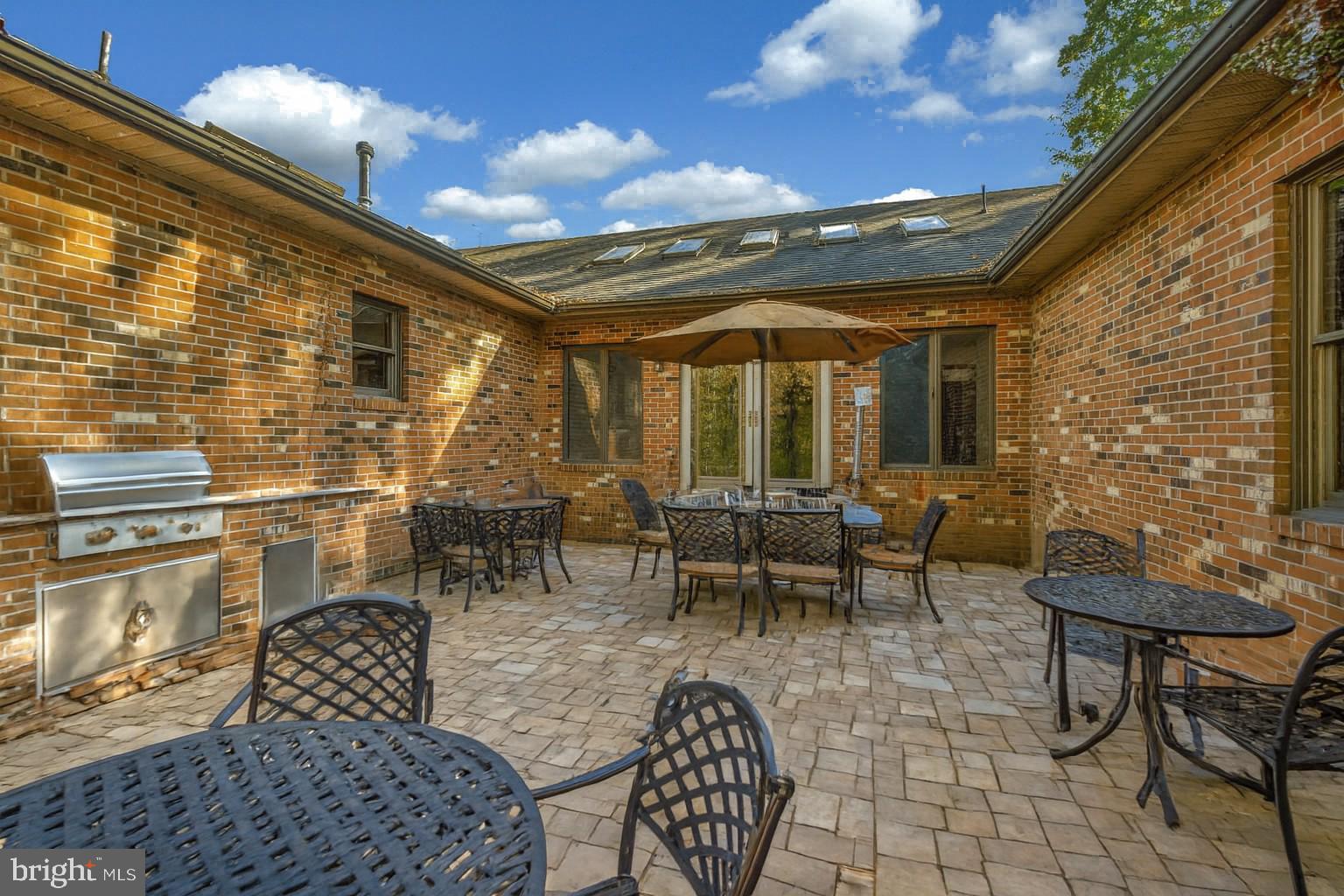 6709 Marye Road Spotsylvania, VA 22551 - Photo 7 of 73 a view of a patio with dining table and chairs with a barbeque grill and couches