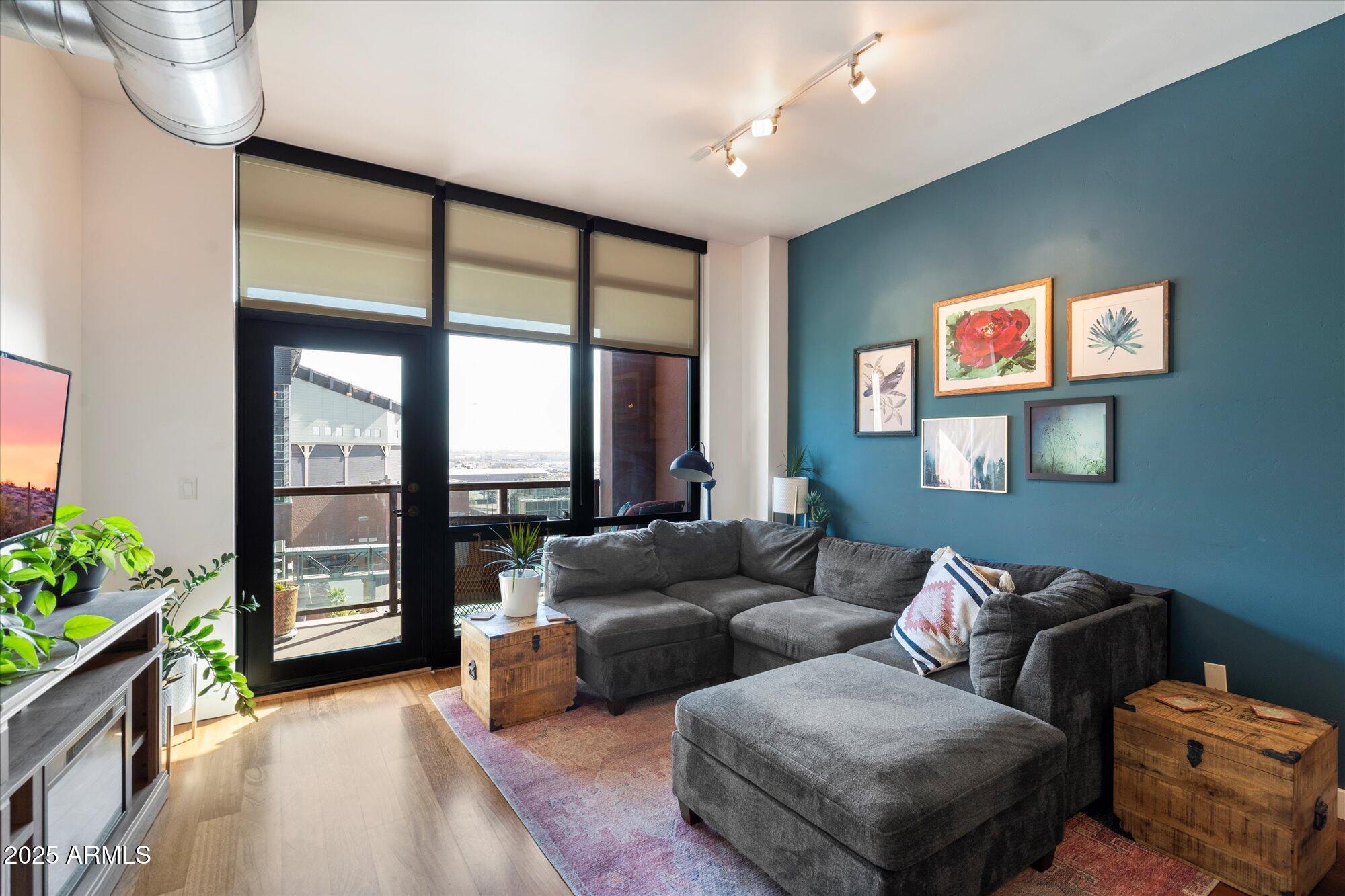 310 South 4th Street, Unit 908 Phoenix, AZ 85004 - Photo 10 of 44 a living room with furniture and a potted plant
