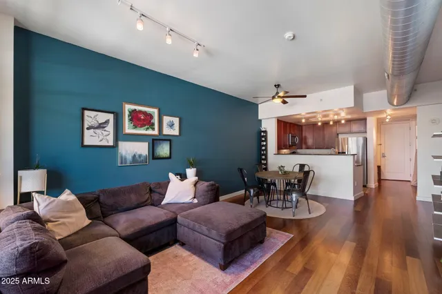 a living room with furniture cabinets and a flat screen tv