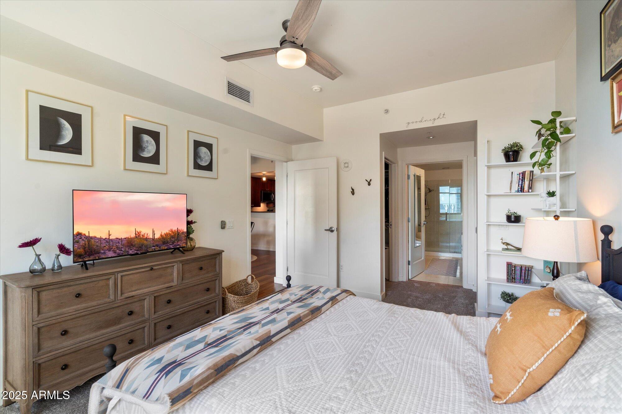 310 South 4th Street, Unit 908 Phoenix, AZ 85004 - Photo 16 of 44 a bedroom with a bed and wooden floor
