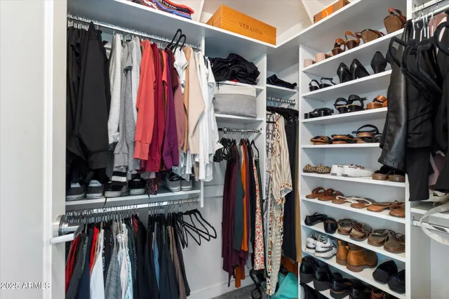 a bedroom with a bed and painting on the wall