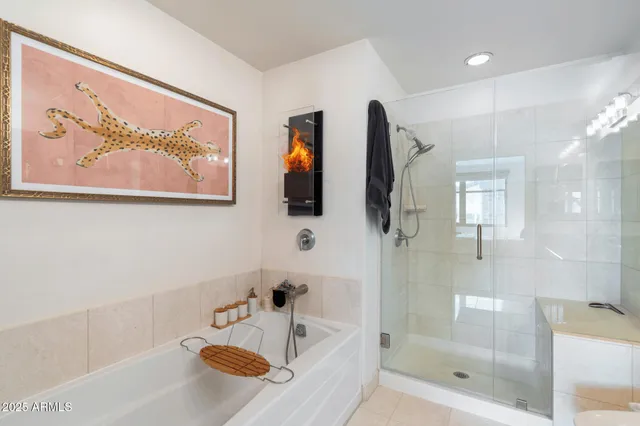 a bathroom with a granite countertop double vanity sink a toilet a mirror and shower