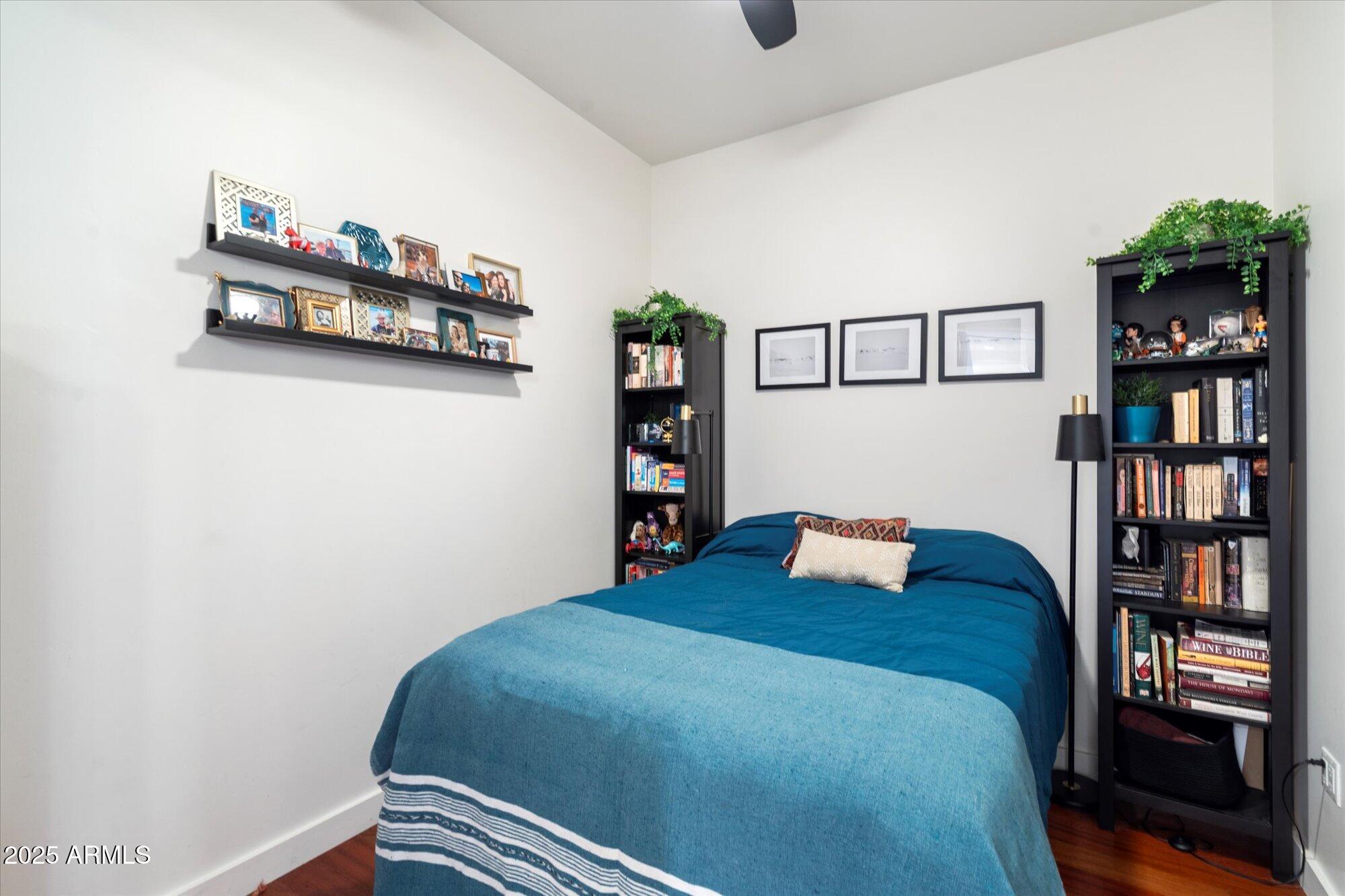 310 South 4th Street, Unit 908 Phoenix, AZ 85004 - Photo 24 of 44 a bedroom with a bed and a book shelf
