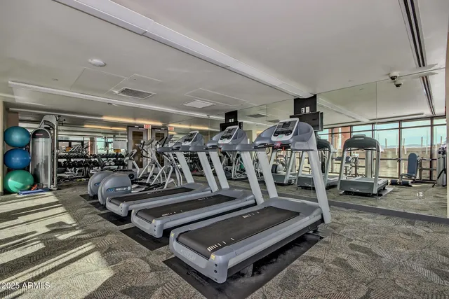 a view of a roof deck with couches and wooden floor