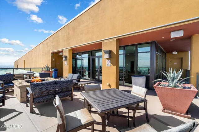 a view of a roof deck with table and chairs with wooden floor