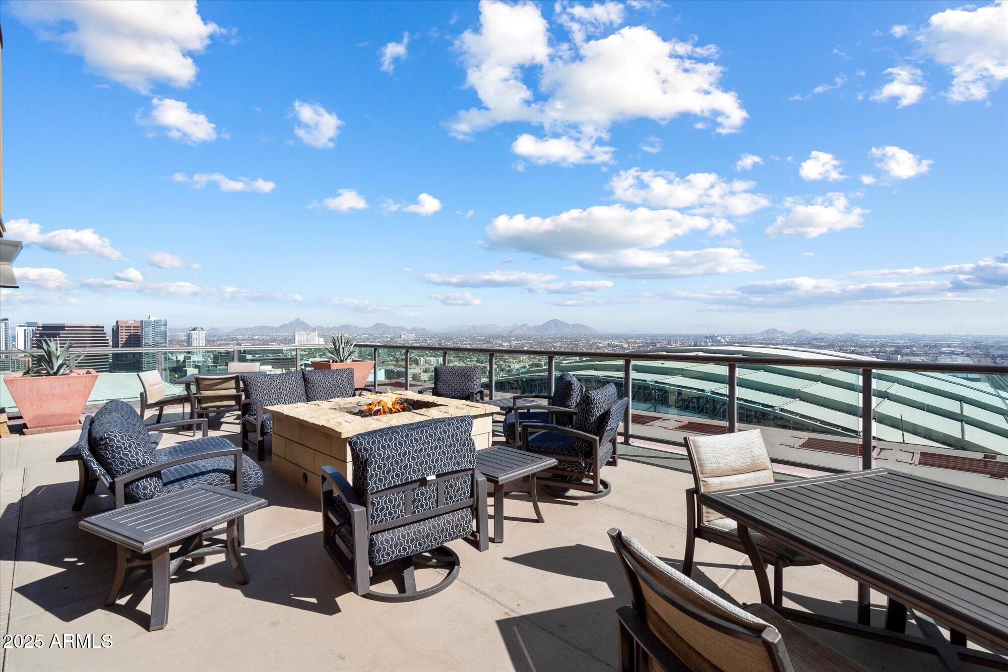 310 South 4th Street, Unit 908 Phoenix, AZ 85004 - Photo 34 of 44 a roof deck with a table and chairs