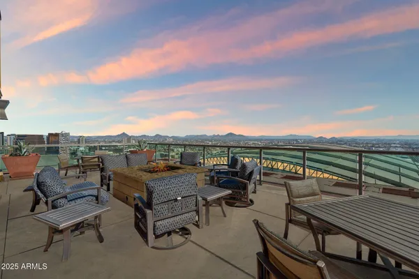 a roof deck with a table and chairs