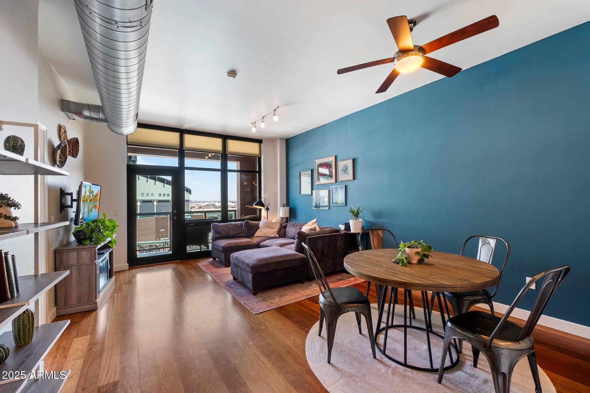 310 South 4th Street, Unit 908 Phoenix, AZ 85004 - Photo 8 of 44 a living room with furniture a flat screen tv and a large window