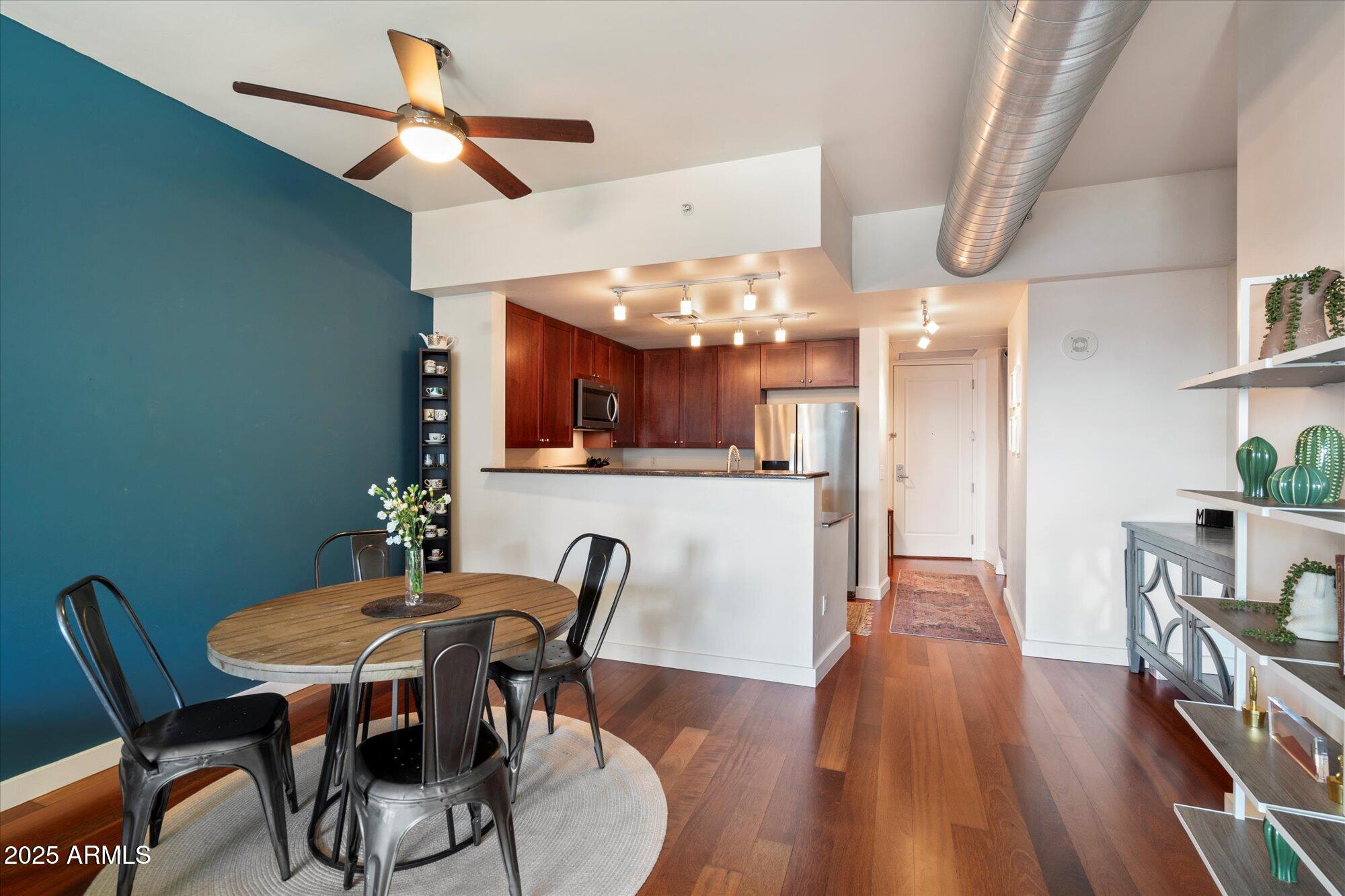 310 South 4th Street, Unit 908 Phoenix, AZ 85004 - Photo 9 of 44 a view of a dining room with furniture and wooden floor