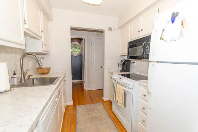 a kitchen with a sink stove and refrigerator