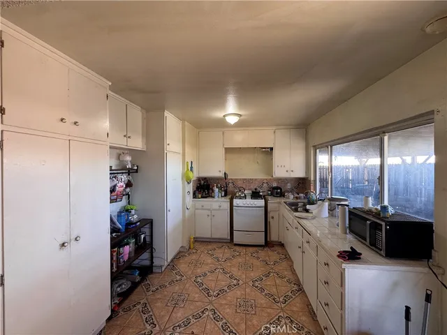 a kitchen with refrigerator and cabinets