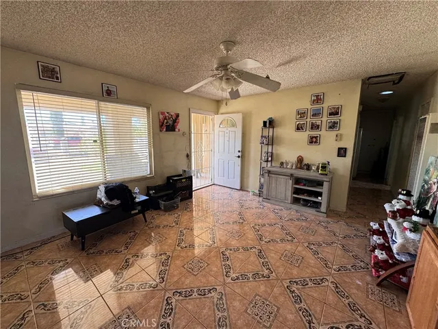 a living room with furniture a flat screen tv and a large window