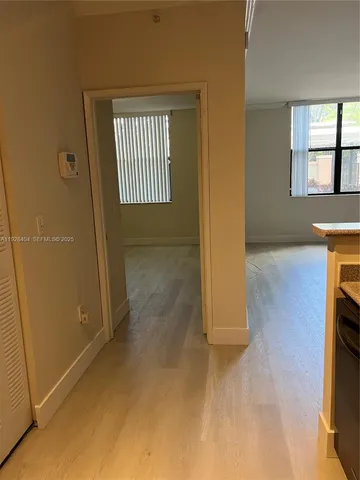 an empty room with windows and closet