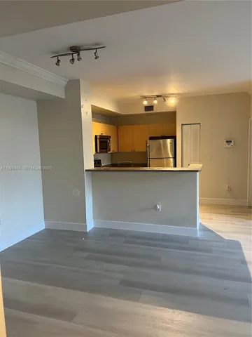 a view of a kitchen cabinets and wooden floor