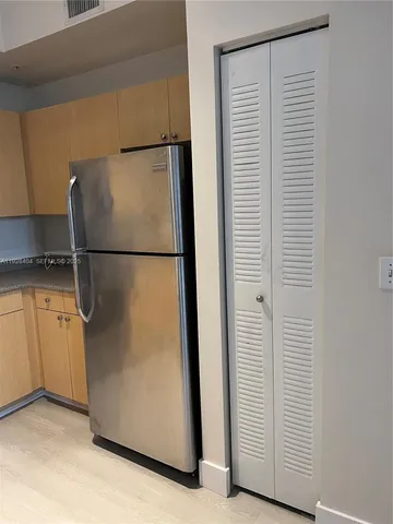 a white refrigerator freezer and a stove sitting inside of a kitchen