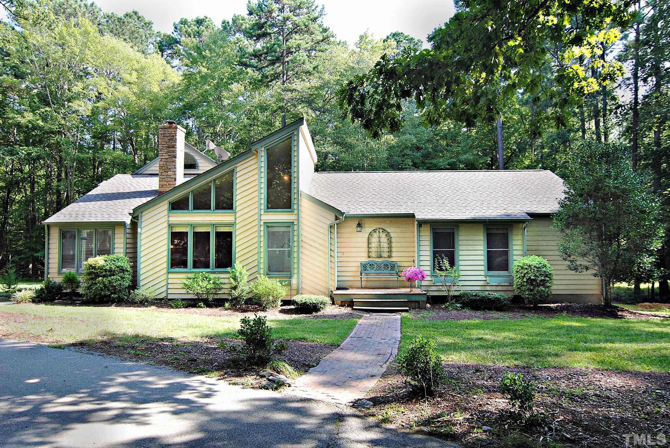 7106 Matthews Road Durham, NC 27712 - Photo 1 of 30 a front view of house with yard and green space