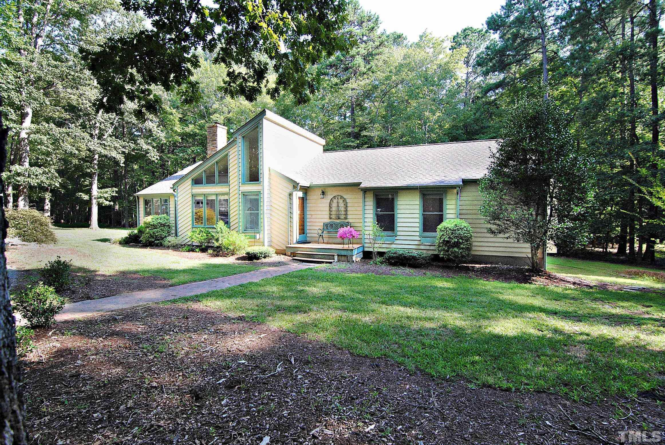 7106 Matthews Road Durham, NC 27712 - Photo 3 of 30 a front view of a house with garden