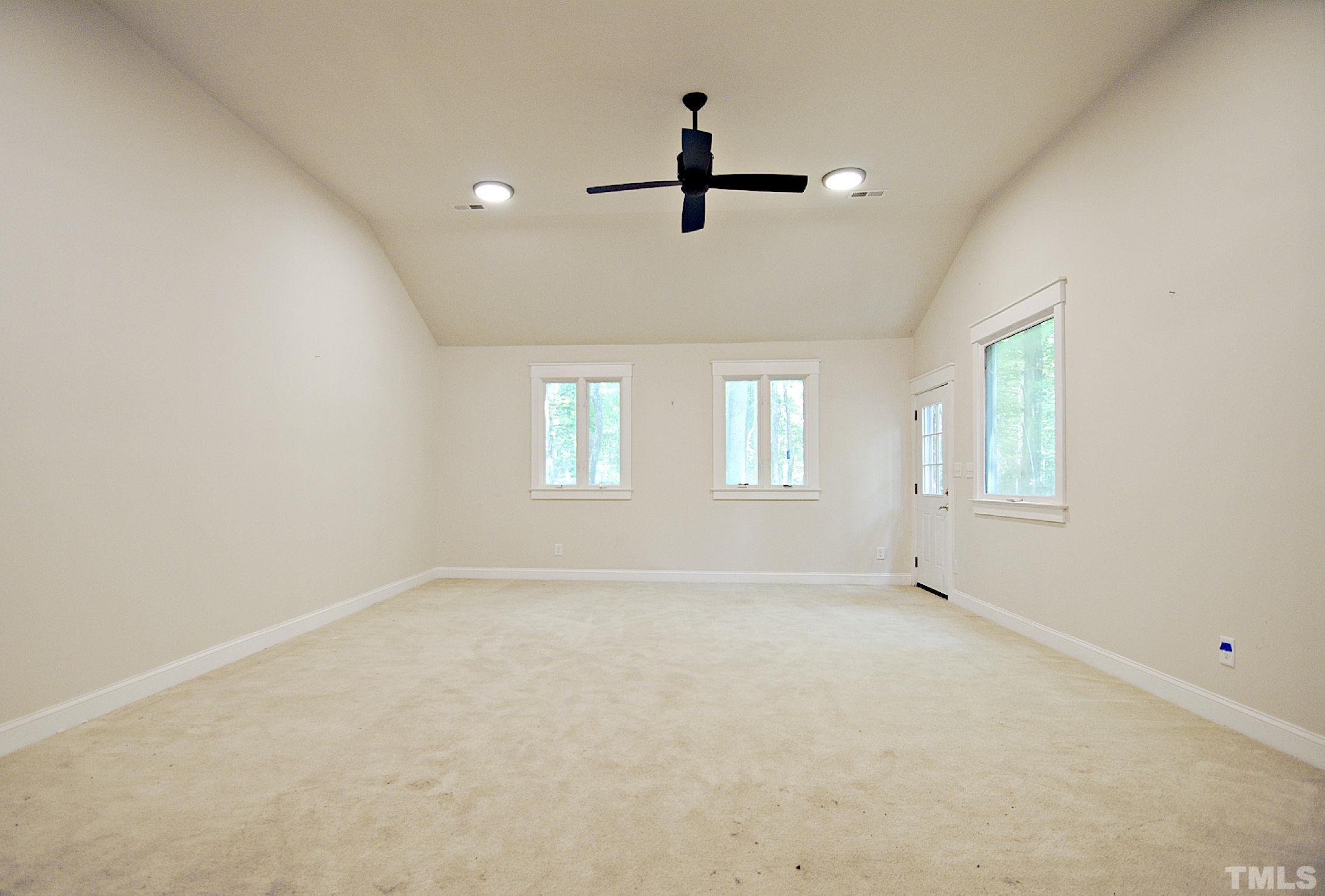 7106 Matthews Road Durham, NC 27712 - Photo 22 of 30 an empty room with windows and fan