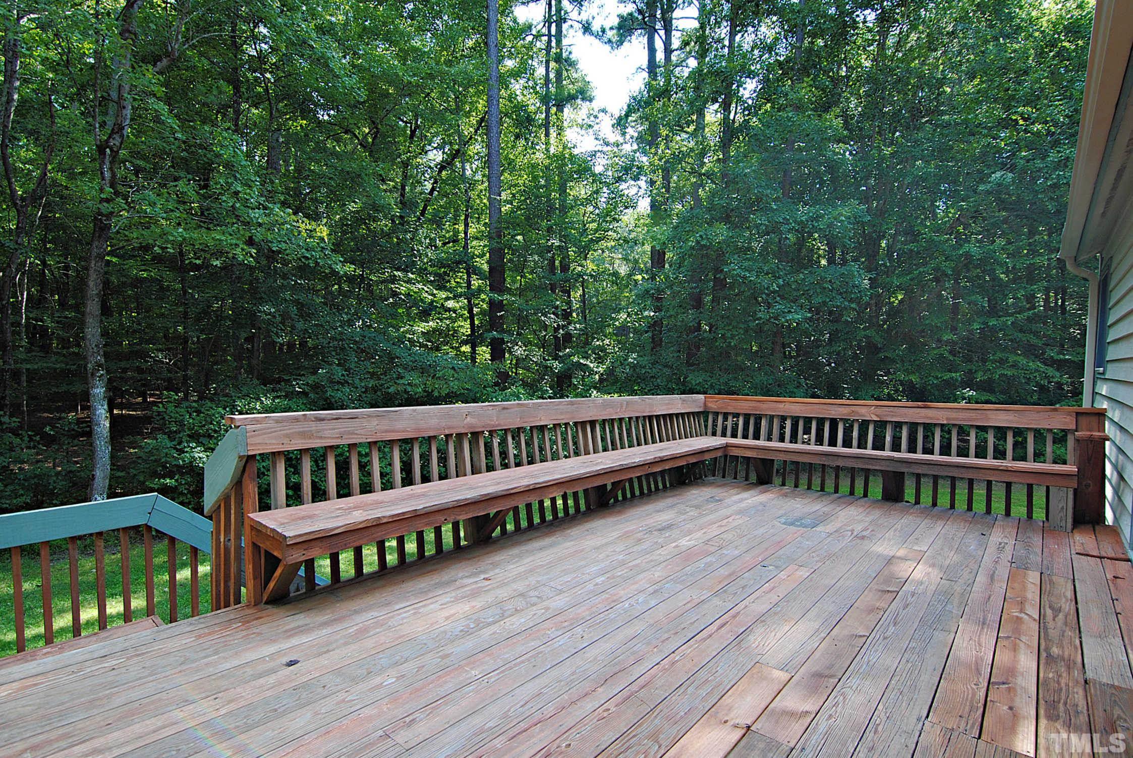 7106 Matthews Road Durham, NC 27712 - Photo 23 of 30 a view of a roof deck with wooden floor and fence