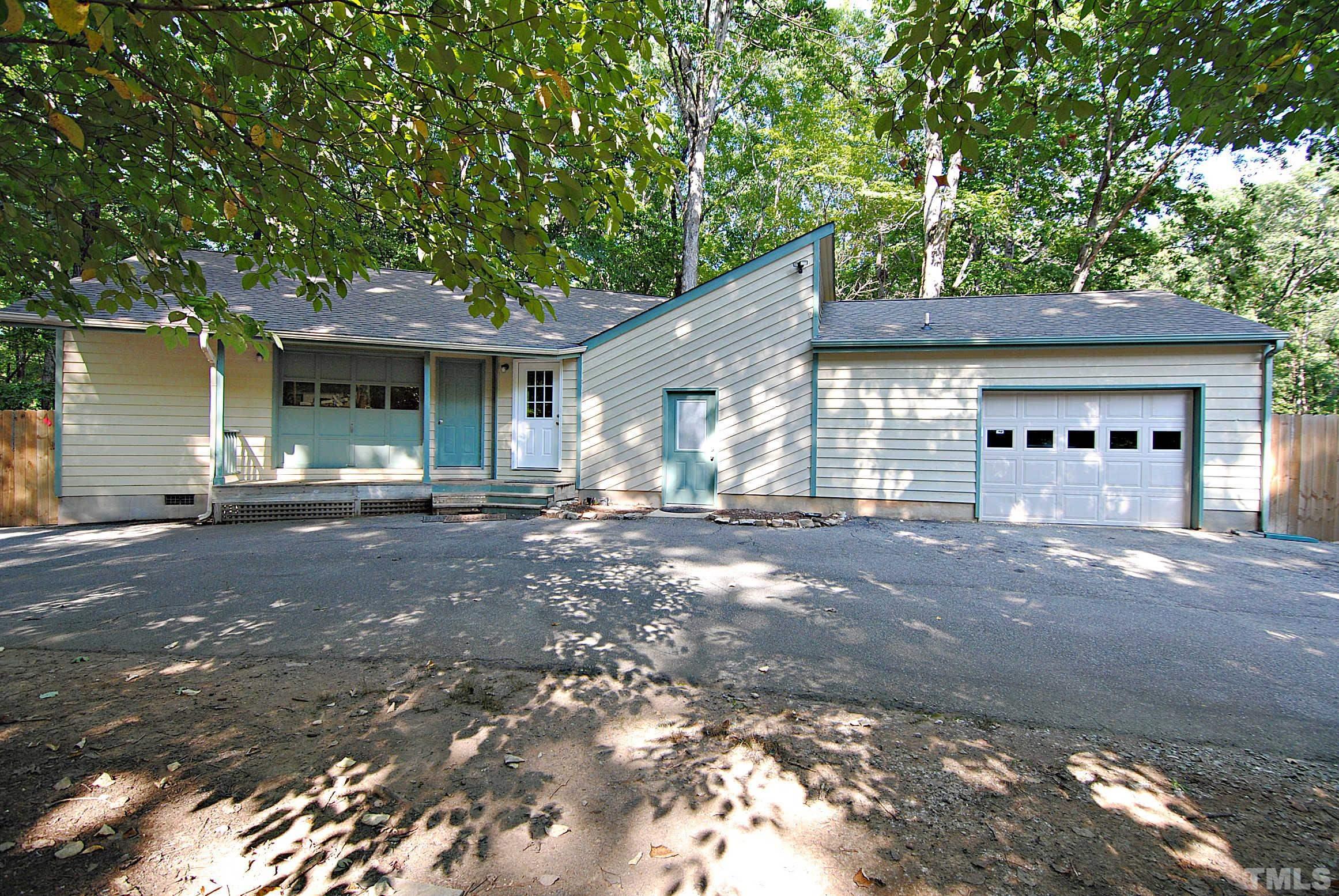 7106 Matthews Road Durham, NC 27712 - Photo 24 of 30 a view of a house with a yard and garage