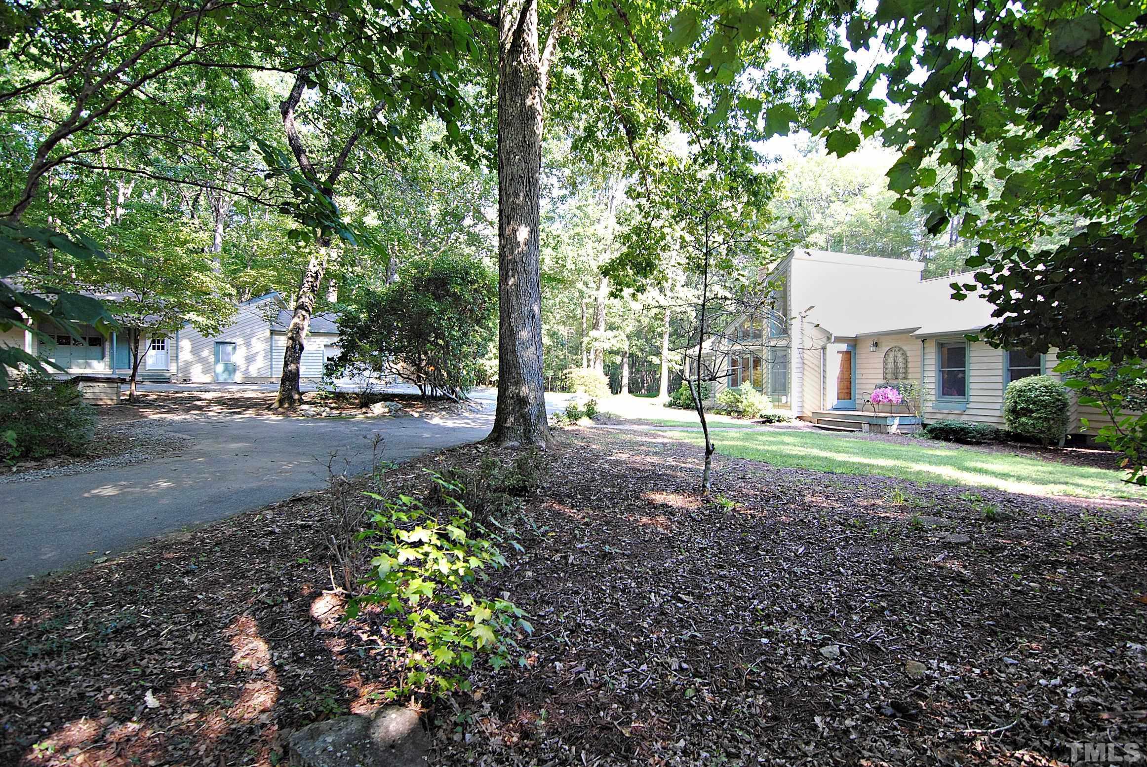 7106 Matthews Road Durham, NC 27712 - Photo 27 of 30 a backyard of a house with lots of green space