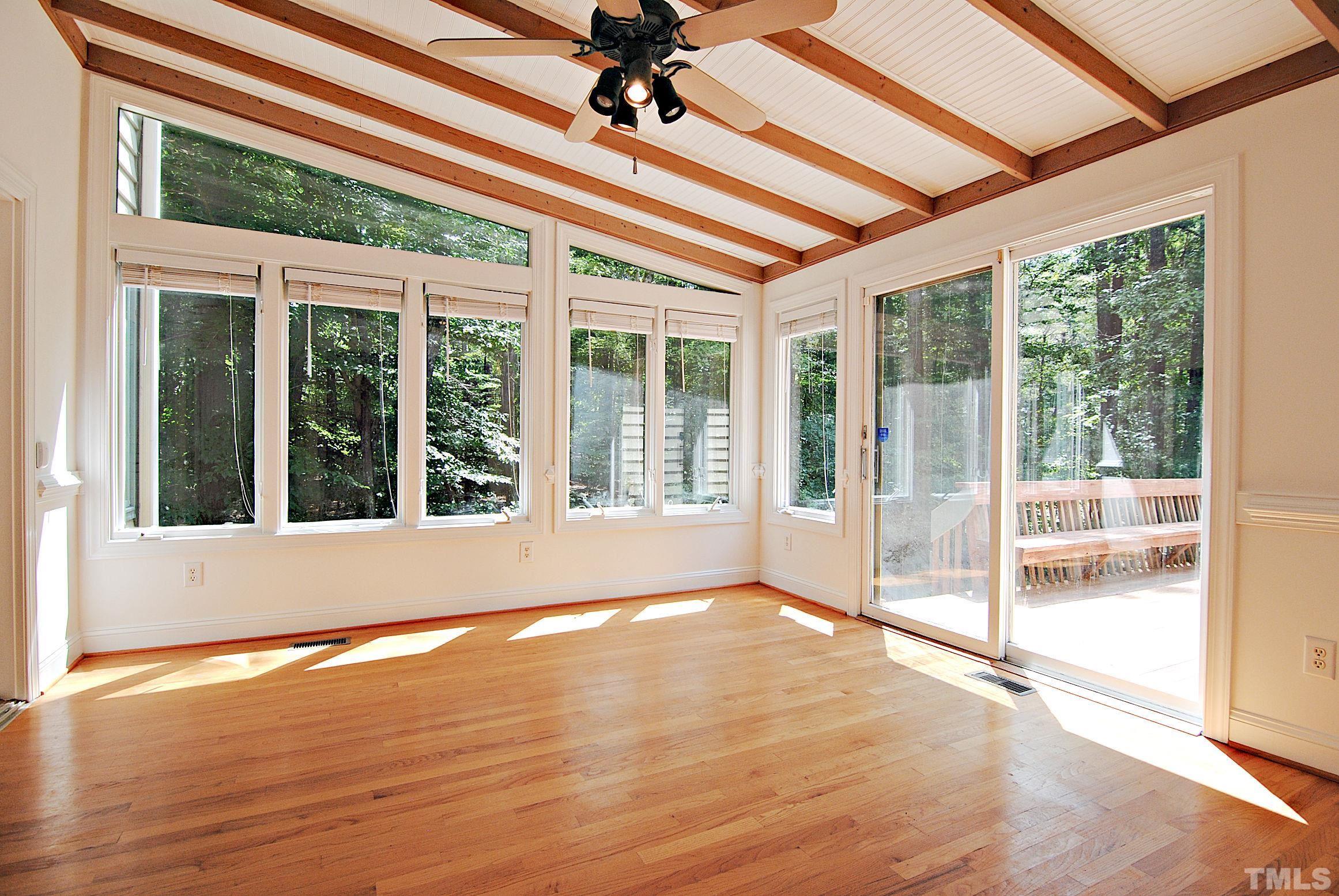 7106 Matthews Road Durham, NC 27712 - Photo 8 of 30 a view of an empty room with wooden floor and a window