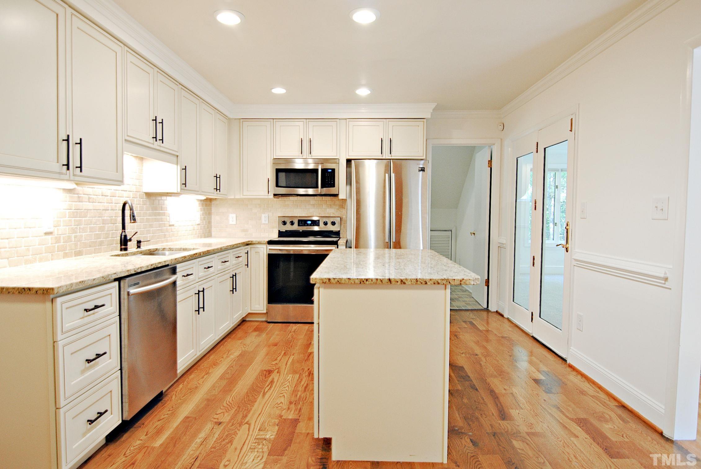 7106 Matthews Road Durham, NC 27712 - Photo 10 of 30 a kitchen with stainless steel appliances a refrigerator stove and sink