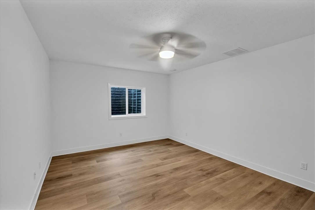 908 Declaration Drive Savoy, IL 61874 - Photo 33 of 41 an empty room with wooden floor and windows