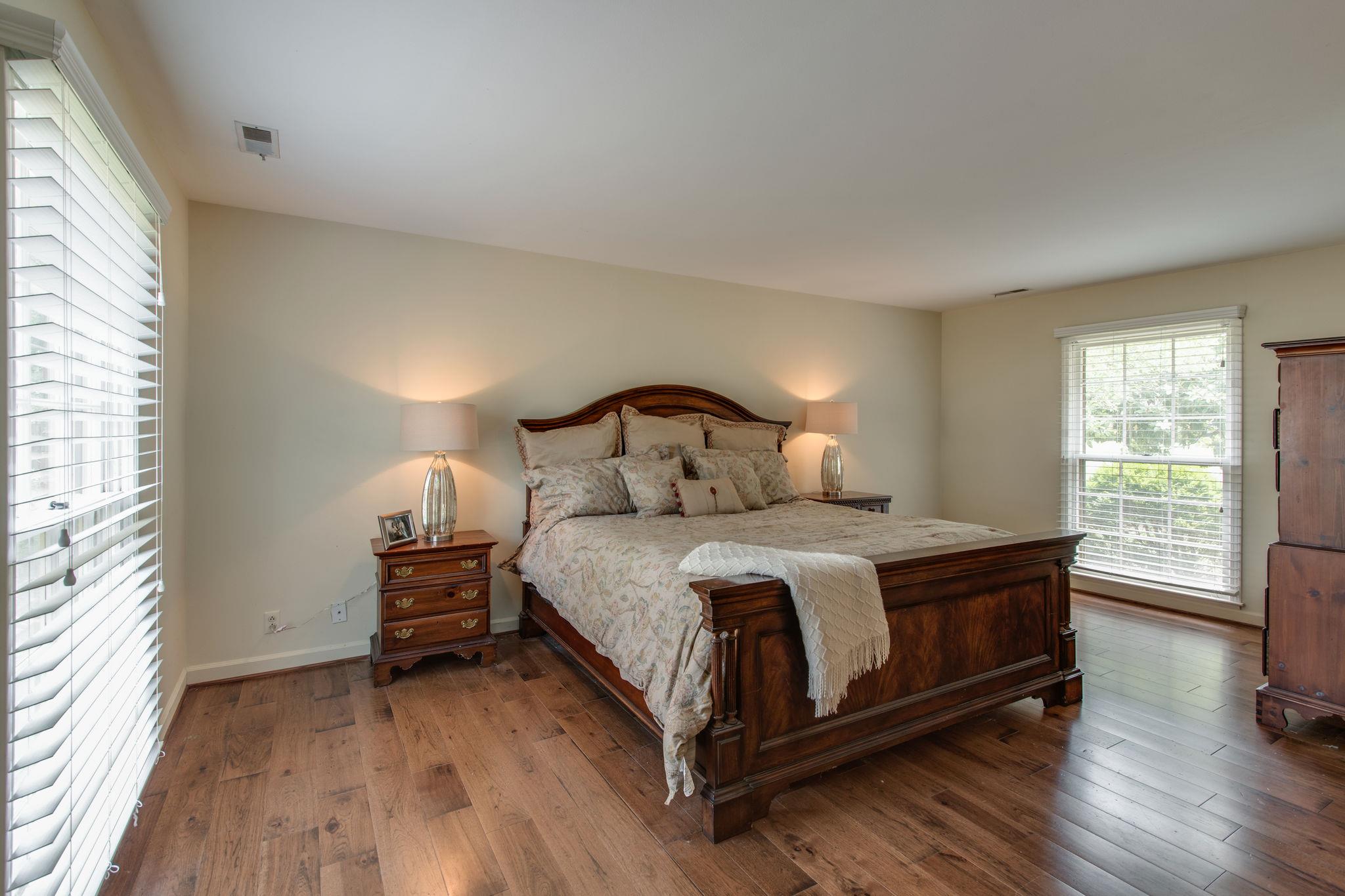 1501 Blue Springs Road Franklin, TN 37069 - Photo 16 of 30 a bedroom with a bed lamp on table and a window