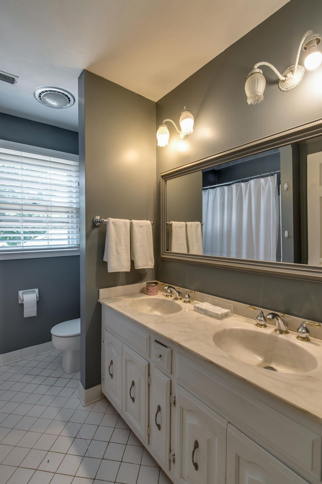 1501 Blue Springs Road Franklin, TN 37069 - Photo 19 of 30 a spacious bathroom with a granite countertop sink a toilet and a mirror
