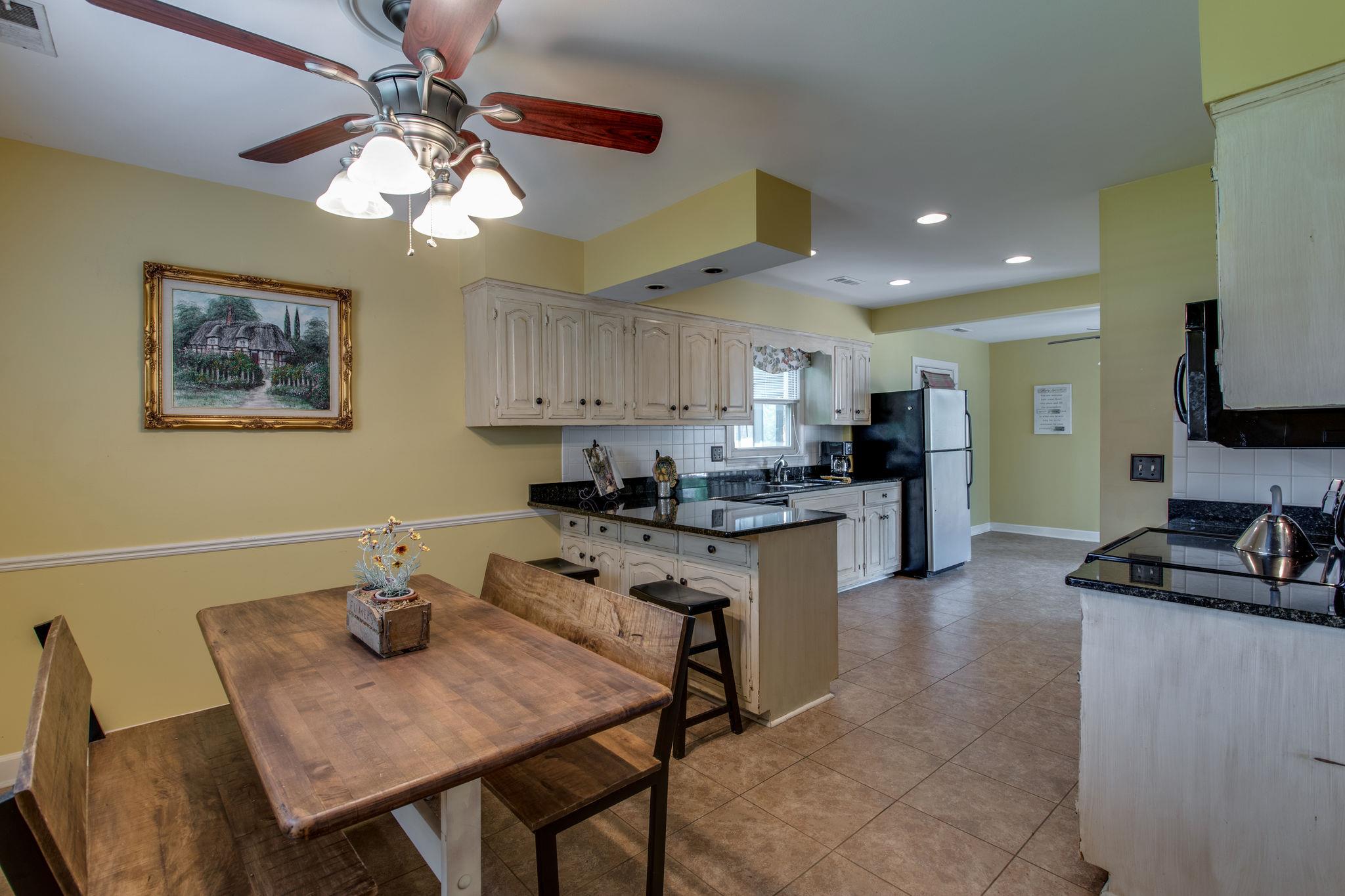 1501 Blue Springs Road Franklin, TN 37069 - Photo 7 of 30 a kitchen with a dining table cabinets and appliances