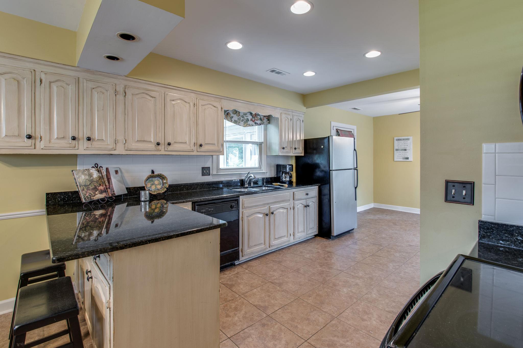 1501 Blue Springs Road Franklin, TN 37069 - Photo 9 of 30 a kitchen with granite countertop a sink stove and refrigerator