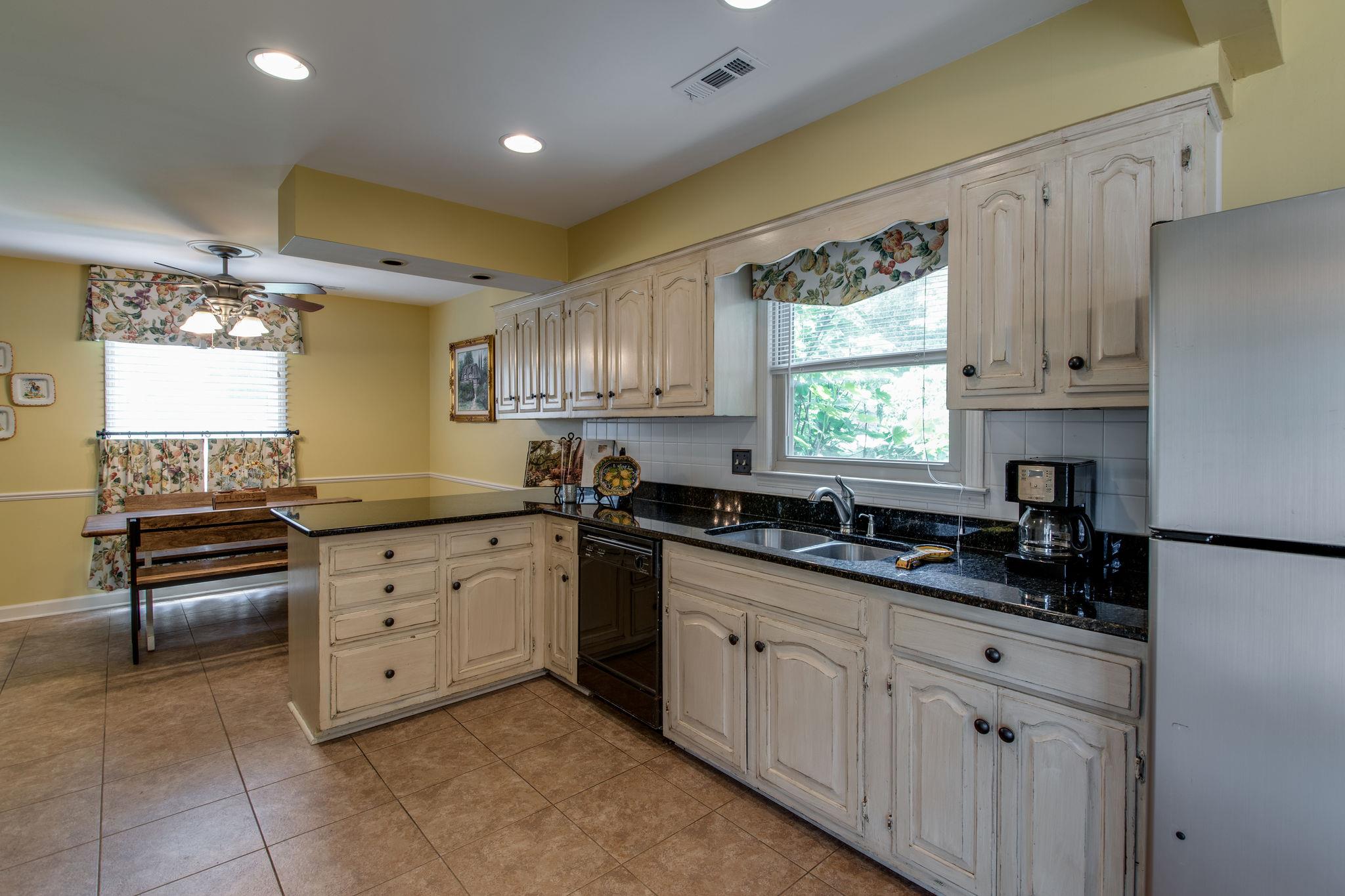 1501 Blue Springs Road Franklin, TN 37069 - Photo 10 of 30 a kitchen with granite countertop a sink window and cabinets
