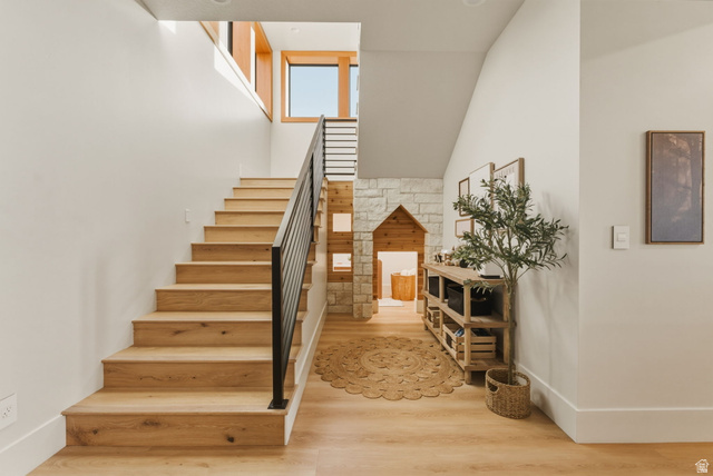 923 North Emery Lane Elk Ridge, UT 84651 - Photo 50 of 101 Staircase featuring wood-finish treads and risers, a matte black metal handrail, and white walls