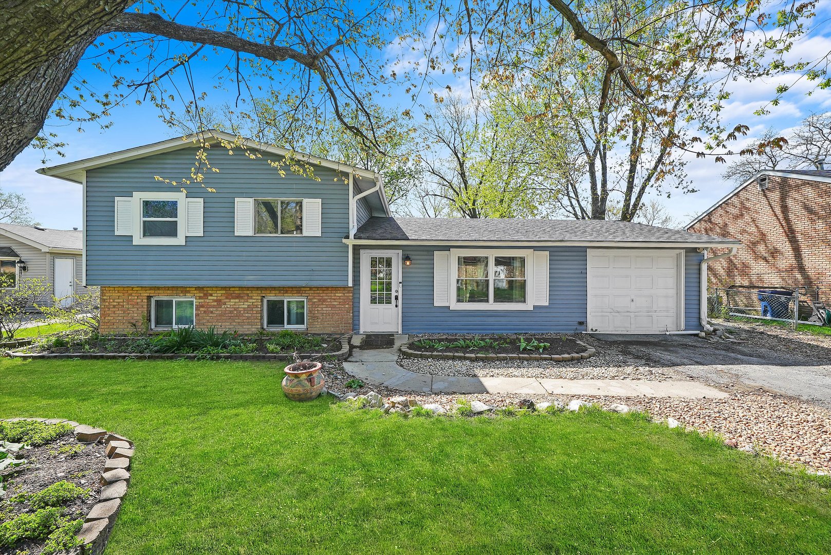 176 Oxford Road Bolingbrook, IL 60440 - Photo 1 of 43 a view of a yard in front of a house with large tree