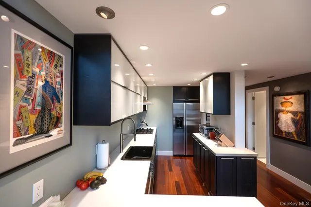 a kitchen with a sink stove and cabinets