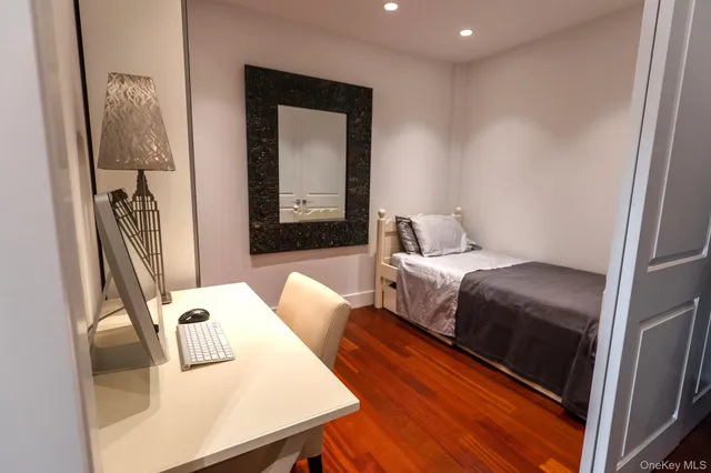 a bedroom with a bed and a dresser in it