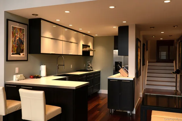 a kitchen with a sink a stove a refrigerator and wooden floor