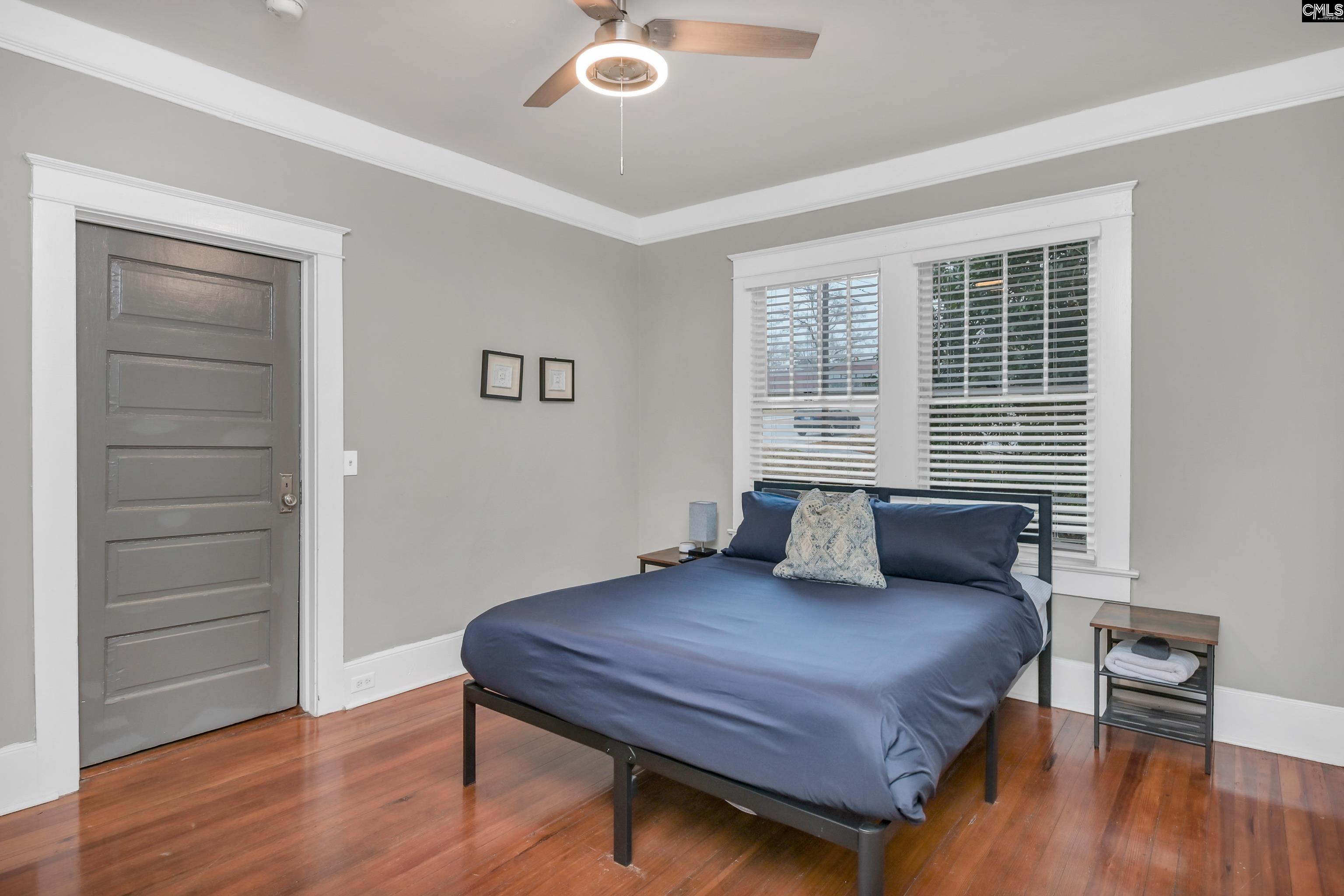 2227 Bull Street Columbia, SC 29201 - Photo 29 of 38 a bedroom with a bed and wooden floor