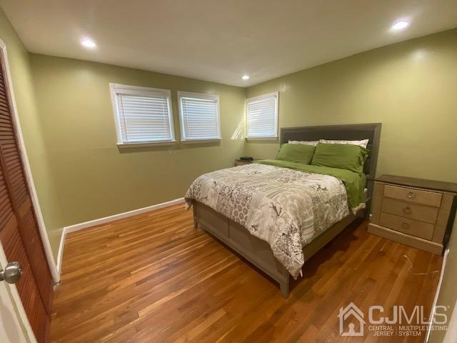 27 Longfield Road New Brunswick, NJ 08901 - Photo 9 of 19 a bedroom with a bed lamp and a large window