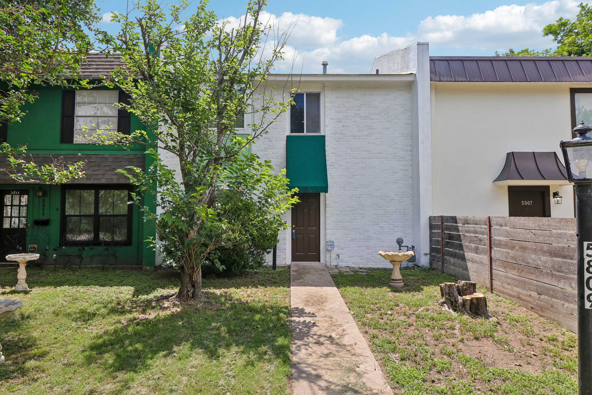 5809 Coventry Lane Austin, TX 78723 - Photo 3 of 35 A classic townhouse facade, featuring a verdant awning and a clear entryway, presents a charming curb appeal.