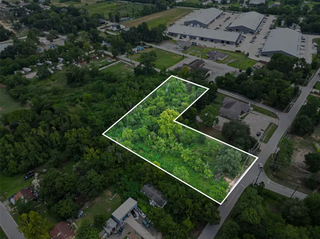 an aerial view of house with a street