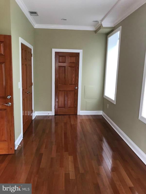3445 14th Street Northwest, Unit 2 Washington, DC 20010 - Photo 4 of 10 an empty room with wooden floor and windows