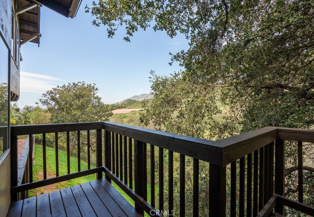 235 Spinks Canyon Road Duarte, CA 91010 - Photo 15 of 62 a balcony with wooden floor and fence