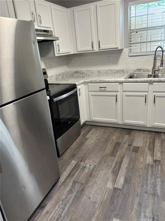 5739 Windfall Lane Lithonia, GA 30058 - Photo 11 of 36 a kitchen with granite countertop a sink a stove a refrigerator and cabinets